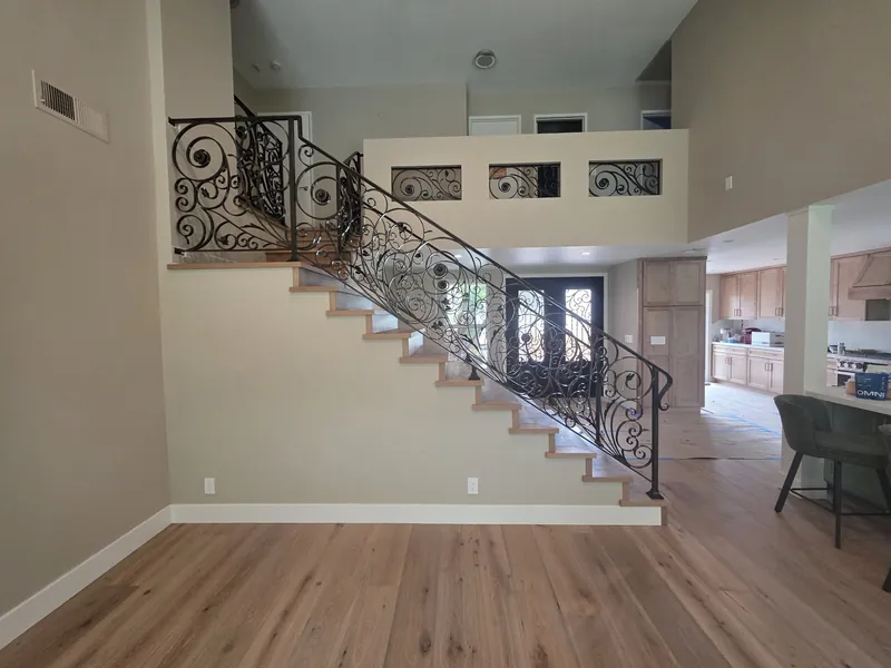 Finished scrollwork stair railing and loft panels