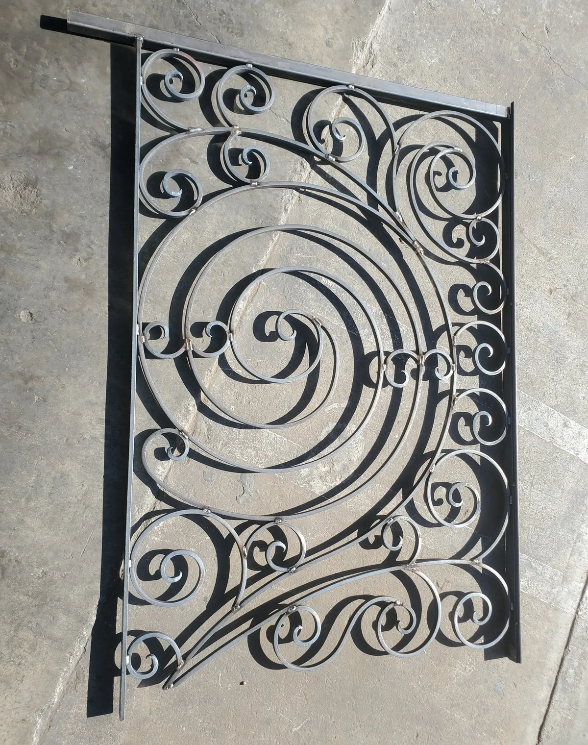 Scrollwork panel in raw steel