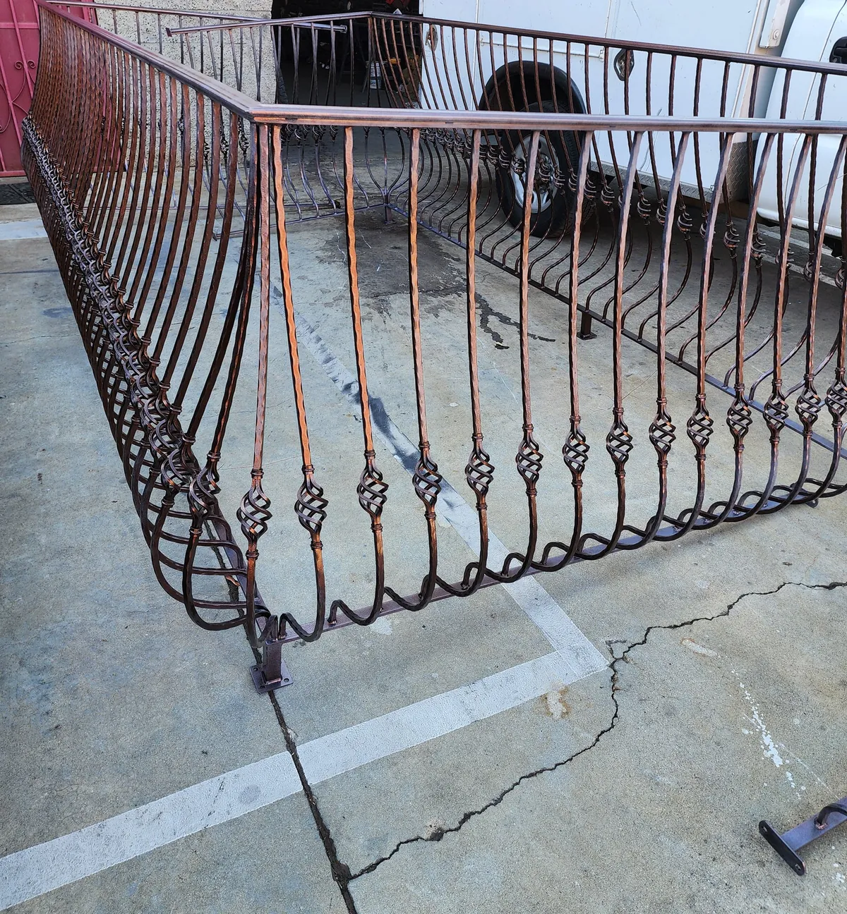 Belly balcony rail with basket balusters, copper finish