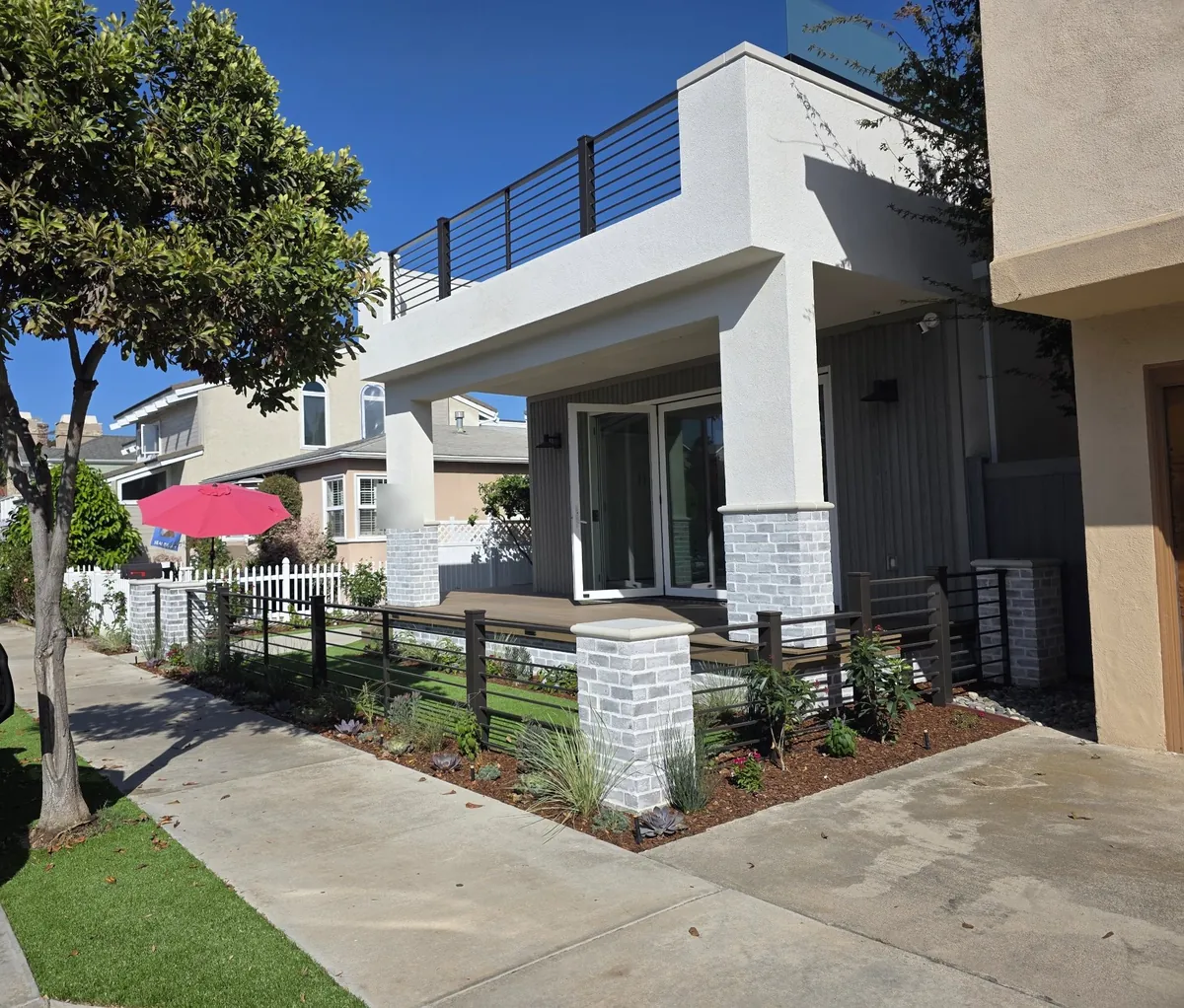 Modern horizontal-bar fence and roof-deck railing on a home